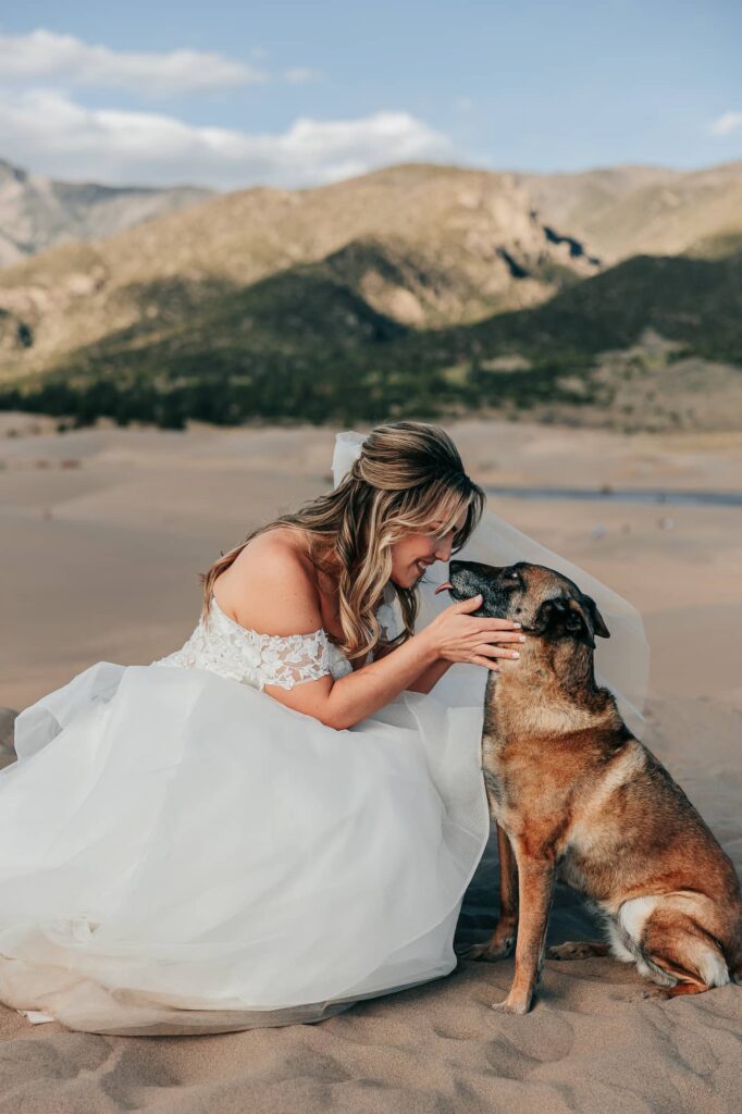 a bride kissing her dog on her wedding day